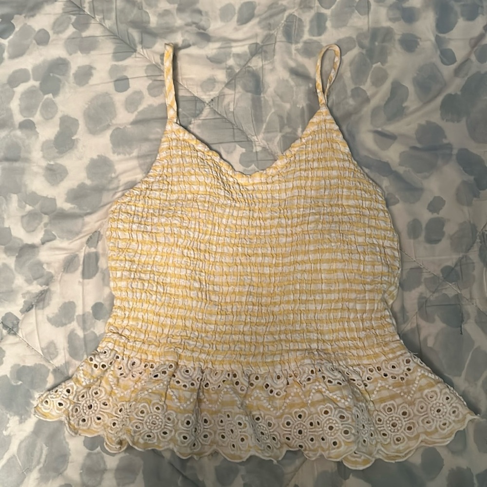 white and yellow striped shirt with flower ruffle at the bottom